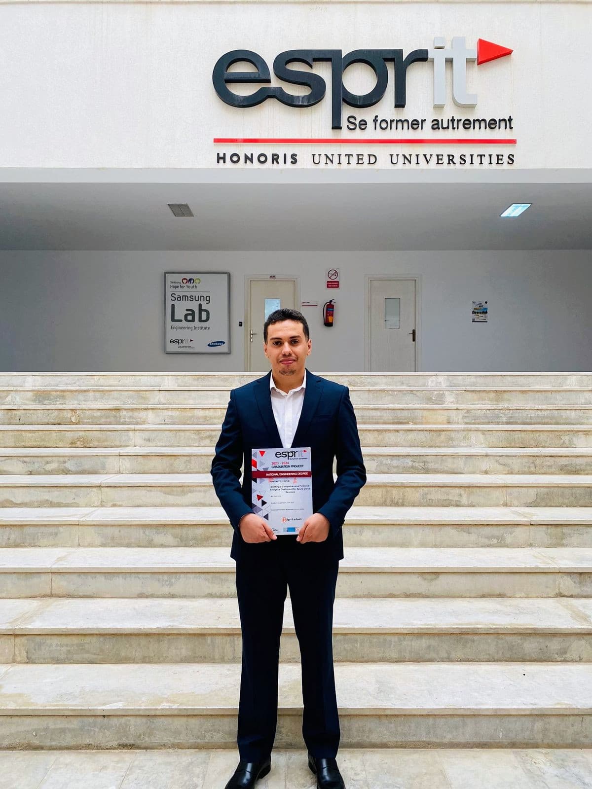 Wael Hcine standing in front of a presentation screen